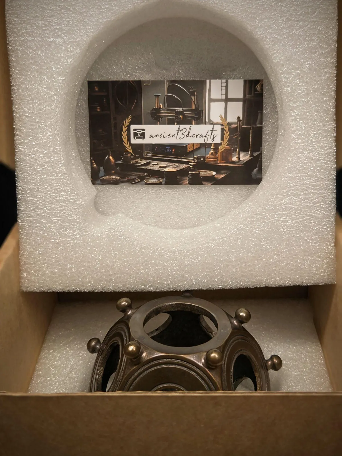 Metal dodecahedron packed in its foam-lined box